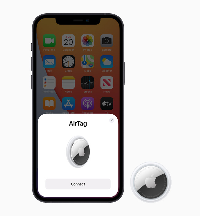iPhone 12 displaying AirTag setup screen, alongside AirTag device.